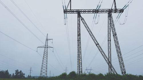 Low angle view of electricity pylon against sky