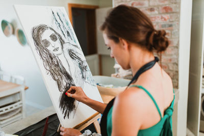 Young woman taking selfie on paper