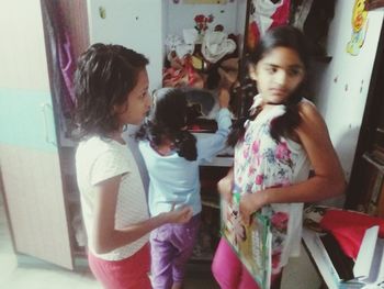 Siblings standing in corridor