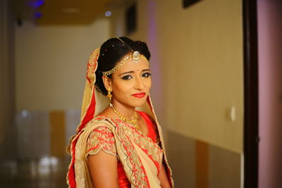 Close-up of bride wearing sari and jewelries