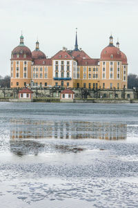 View of river in city against clear sky