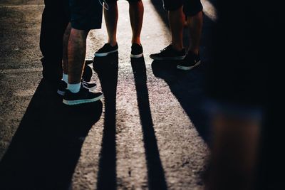 Low section of people standing on road