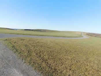 Scenic view of landscape against clear blue sky