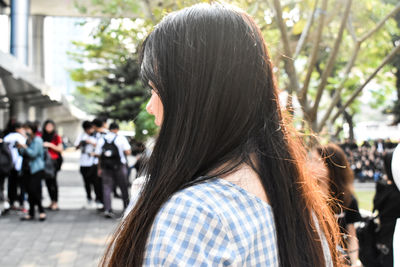 Rear view of woman walking on street in city