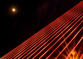 Close-up of illuminated light trails against sky at night