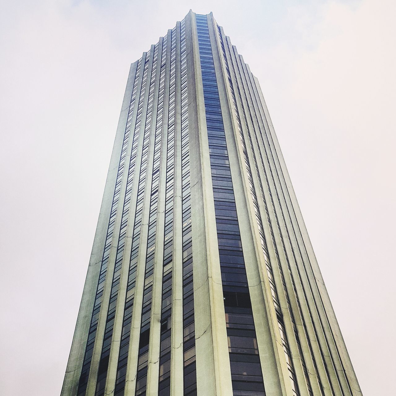 architecture, low angle view, built structure, building exterior, tall - high, skyscraper, modern, tower, office building, city, clear sky, sky, tall, building, day, outdoors, no people, glass - material, capital cities, travel destinations