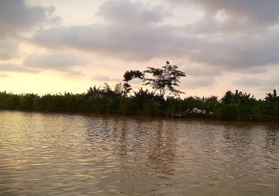 Scenic view of lake against sky at sunset