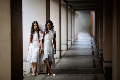 Woman standing in corridor of building