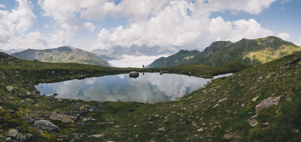 Young woman hiking with her son in the baby carrier at the pyrenees