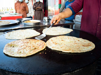 People cooking paratha roti