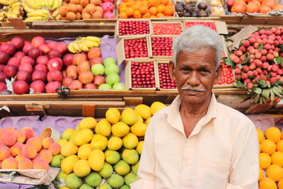 Close up portrait of an old man selling fruits on a pavement in mumbai