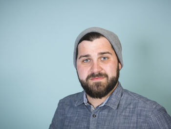 Portrait of man against blue background