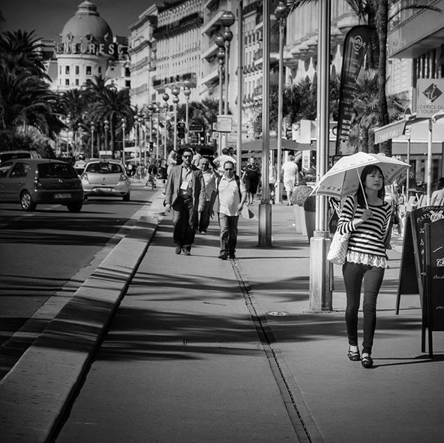 building exterior, walking, architecture, built structure, full length, lifestyles, city, person, men, street, rear view, city life, leisure activity, casual clothing, city street, on the move, sidewalk, building