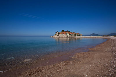 Scenic view of sea against clear blue sky