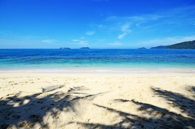 Scenic view of sea against blue sky