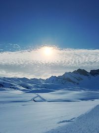 Scenic view of snow covered mountains against sky