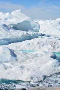 Scenic view of frozen lake against sky