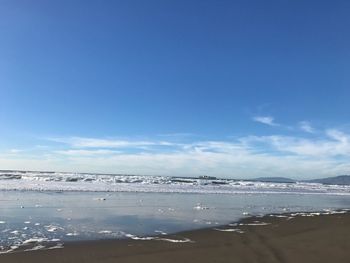 Scenic view of sea against blue sky