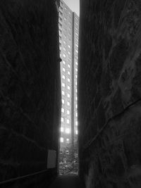 Low angle view of sunlight streaming through window in building