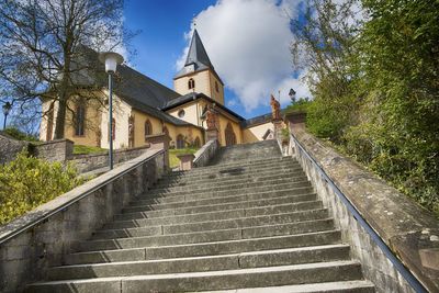 Low angle view of stairs along buildings