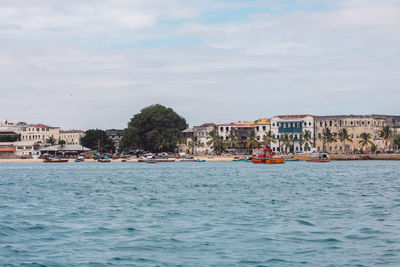 Boats in sea against sky