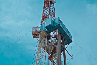 Low angle view of tower against blue sky