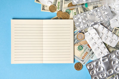 High angle view of open book against blue background