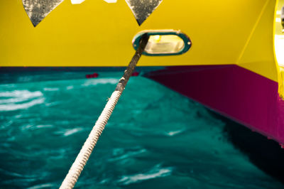 High angle view of rope at boat moored in sea