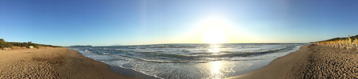 Panoramic view of beach against clear sky