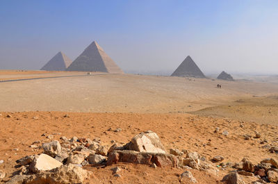 Scenic view of pyramids in desert against sky