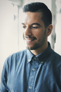 Mid adult entrepreneur smiling in cafe