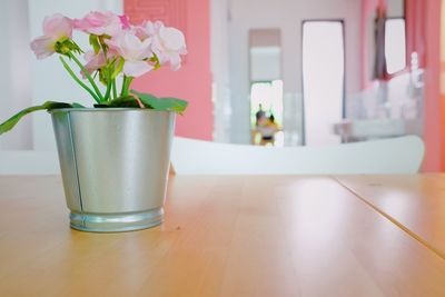 Close-up of potted flower vase on table at home