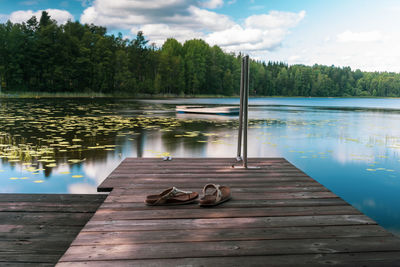 Pier on lake against sky