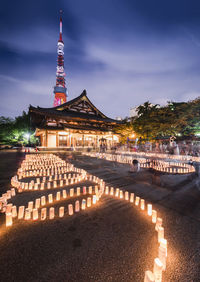 Handmade japanese washi paper lanterns aligned in circles illuminating the zojoji temple.