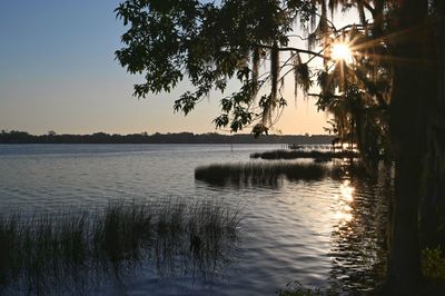 Scenic view of lake against sky during sunset