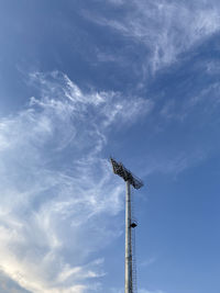 Low angle view of flood light against blue sky