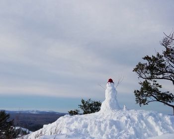 Snowman ontop of a mountain