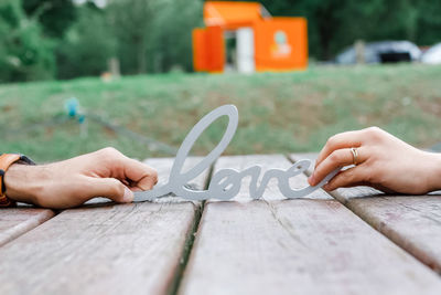 Midsection of person holding paper with text