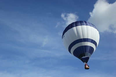 Low angle view of hot air balloon flying against sky