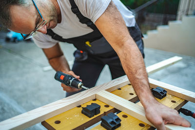 Midsection of man working at workshop