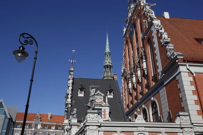 Statues on house of the blackheads against clear blue sky