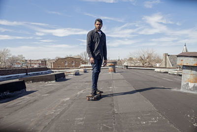 A young man skateboarding.