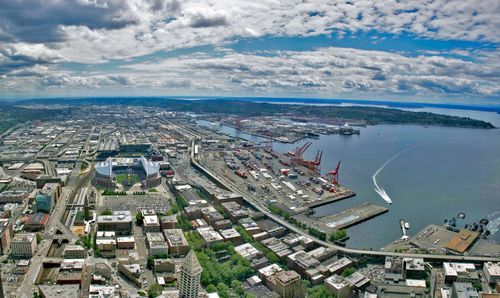 High angle view of townscape by sea against sky