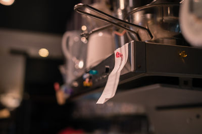 Close-up of paper hanging at kitchen in cafe