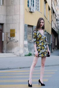 Portrait of young woman standing on street