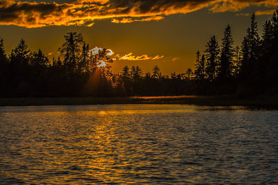 Scenic view of lake against cloudy sky