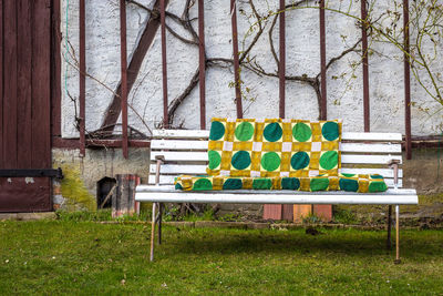 Patterned blanket on bench in yard