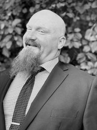 Bald man looking away while standing outdoors