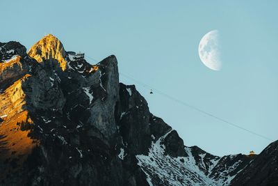 Low angle view of majestic mountains against clear sky