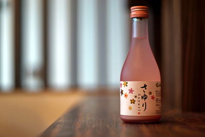 Close-up of glass bottle on table